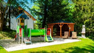 a playground with a small house and a slide at Apartamenty Good Time- Mariental Residence - Centrum in Szklarska Poręba