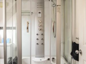 a bathroom with a shower and a toilet at Peacock Cottage - Uk36422 in Talybont