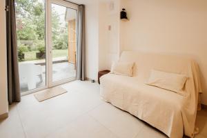 a bedroom with a bed and a large window at La Parenthèse - Appartement central avec terrasse in Pontarlier