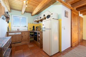 a kitchen with a white refrigerator and wooden cabinets at Atempause in Fehmarn