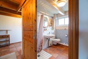 a bathroom with a toilet and a sink at Atempause in Fehmarn +49 photos