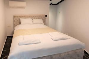 a bed in a room with two pillows on it at Hotel Dream Crown in Bhopal