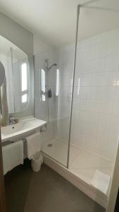 a bathroom with a shower and a sink at ibis Cambrai in Cambrai +71 photos