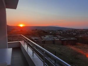 a sunset from the balcony of a house at Duplex Villa with Panoramic Sea View in Gokceada Town