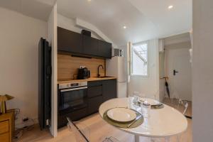 a kitchen with a table and a stove and a counter at l'Onyx in La Rochelle