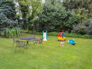 a yard with a table and chairs and playground equipment at Homestead in Long Sutton