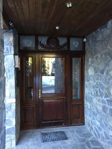 a large wooden door in a stone building at Muller Apartment in Sinaia