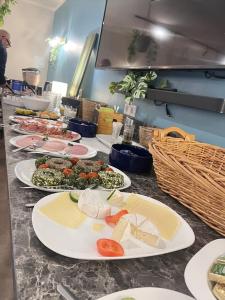 a buffet with plates of food on a counter at Erholung pur in der Strandhussiedlung Rügen - Bungalow Ferienwohnung - bis 5 Personen - nur 100m zum Naturstrand - mitten im Kiefernwald - Ideal für Paare & Familien - Hunde herzlich willkommen in Dranske