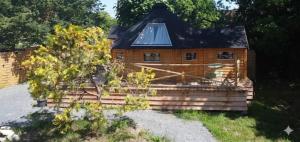 a small wooden house with a roof at Auvergne Kota in Brugheas +11 photos