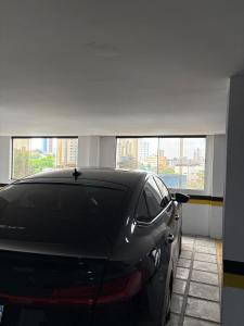 a car is parked in a parking garage at Apartamento Centro Campina Grande in Campina Grande