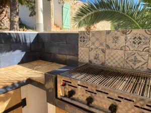 a barbecue grill sitting on top of a patio at Malhada do Sao in Tavira