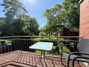a patio with two chairs and a table on a balcony at Nordlicht in Krummhörn