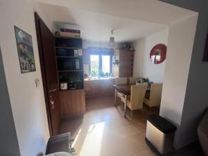 a kitchen and dining room with a table and chairs at Vadkörte Balaton Apartman in Balatonfůzfő +17 photos