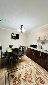 a living room with a table and chairs and a kitchen at Asia-palace in Chon-Sary-Oy +26 photos
