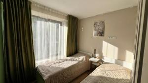 a hotel room with two beds and a window at Asia-palace in Chon-Sary-Oy