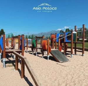 a row of playground equipment in the sand at Asia-palace in Chon-Sary-Oy