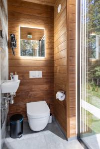 a bathroom with a toilet and a sink at Forest Reflection Minivilla in Partsi