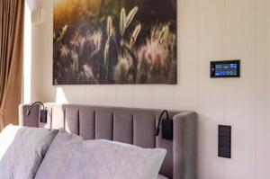 a bedroom with a bed and a painting on the wall at Forest Reflection Minivilla in Partsi +22 photos