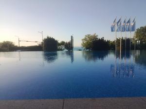 a large body of water with flags in the background at Blue Marina Sunset in Sozopol