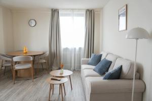 a living room with a couch and a table at KasselRooms Design Studio in Kassel
