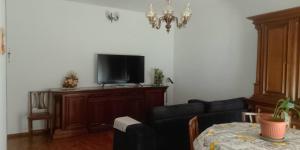 a living room with a couch and a flat screen tv at I Ponti in Fanano