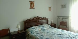 a bedroom with a bed and two lamps and a chair at I Ponti in Fanano