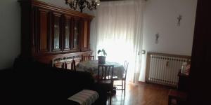 a living room with a table and a window at I Ponti in Fanano +2 photos