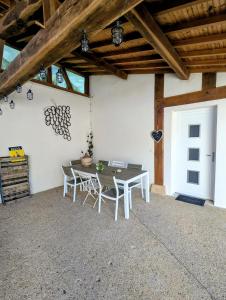 a patio with a table and chairs in a building at Gite Entre Pierre et Come in Chablis