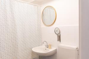 a bathroom with a toilet and a sink and a mirror at KasselRooms Design Studio in Kassel