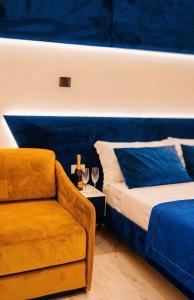 a bedroom with a couch and a bed and a chair at Villa SOLIS in Vlorë