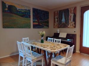 a dining room with a table and chairs and a piano at B&B Galleria 37 in Canosa Sannita