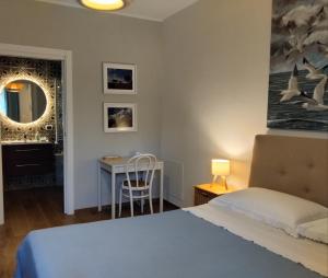 a bedroom with a bed and a table and a mirror at B&B Galleria 37 in Canosa Sannita