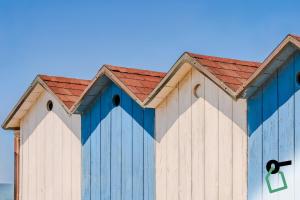 a blue and white building with a red roof at Hotiday Marina di Cecina in La Cinquantina