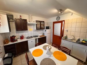 a kitchen with a table with a swan on it at Luca Apartman in Esztergom +9 photos