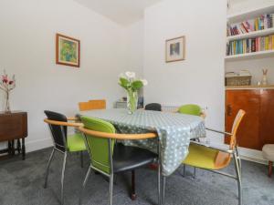 a dining room with a table and chairs at Gwynfa in Colwyn Bay