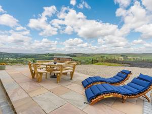a patio with a table and chairs and a view at The Stables in Stanhope