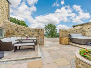 a patio with a table and a bench at The Stables in Stanhope
