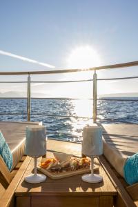 a table on a boat with a plate of food on it at Luxury Floating Apartment - Amor in Split