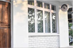 a front door of a house with a window at khim Retreat in Mirik +4 photos