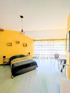 a bedroom with a bed in the middle of a room at Gite Entre Pierre et Come in Chablis