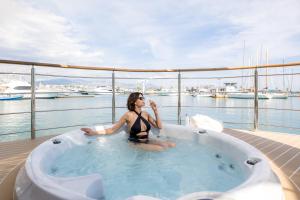 a woman sitting in a hot tub on a boat at Luxury Floating Apartment - Amor in Split +18 photos
