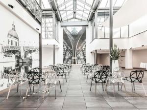 a room with chairs and tables in a building at Novotel Toulouse Centre Wilson in Toulouse