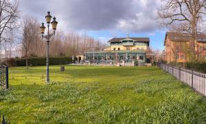 a large house in a field with a street light at Hotel Bihler in Bad Aibling