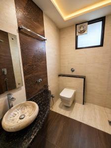 a bathroom with a sink and a toilet at Urbana Luxury AC Duplex Bungalow with Pergola Terrace in Nagpur