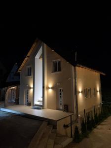 a house with a large window on the side of it at night at Lux Studio Apartments in Žabljak