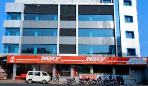 a large building with motorcycles parked in front of it at TRIVPODS Capsule Hotel in Trivandrum