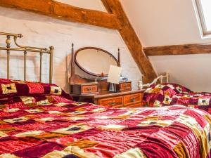 a bedroom with a bed and a large mirror at Ty Fferm Hen - Uk36420 in Talybont