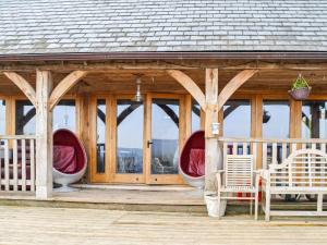 a gazebo with two white chairs and a porch at Ty Nofio - Uk36421 in Talybont