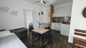 a kitchen and dining room with a table and chairs at Enalia Apartments in Korissia +19 photos