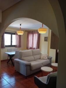 a living room with a couch and a table at Apartamentos El Brezo in Albarracín +36 photos